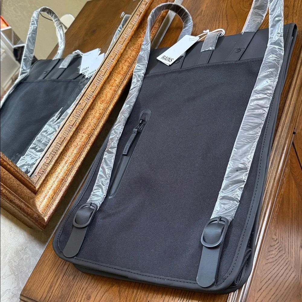 Rains Black Backpack. Clean and ever contemporary.